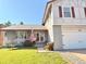 Charming home boasting a lush green lawn, a welcoming front porch adorned with flowers, and a two-car garage at 5255 S Waco St, Centennial, CO 80015