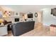 Open living room with sleek wood flooring, modern décor, and a painted brick fireplace at 5255 S Waco St, Centennial, CO 80015