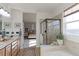 Spa-like bathroom with double vanity and walk-in shower at 14307 Waterside Ln, Broomfield, CO 80023