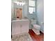 Light and airy powder room with white vanity and wood floors at 14307 Waterside Ln, Broomfield, CO 80023