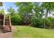 Backyard with stairs to deck, a slide, and greenery for outdoor enjoyment at 8571 W 71St Cir, Arvada, CO 80004