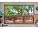 Large picture window showcases the backyard deck with outdoor seating and mature trees at 8571 W 71St Cir, Arvada, CO 80004