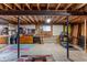 Unfinished basement with exposed ceiling, concrete floor, and storage at 8571 W 71St Cir, Arvada, CO 80004
