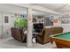 Finished basement area with a pool table, TV, comfortable seating, and walkout access at 8571 W 71St Cir, Arvada, CO 80004
