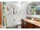 Well-lit bathroom featuring a vanity with a granite countertop, wall decals, and tile flooring at 8571 W 71St Cir, Arvada, CO 80004