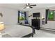 Bedroom with dark furniture, gray carpet, and a view of the outdoors from two windows at 8571 W 71St Cir, Arvada, CO 80004