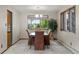 Dining room with a classic wooden table, upholstered chairs, and plenty of natural light at 8571 W 71St Cir, Arvada, CO 80004