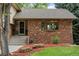 Close-up of the house's brick facade and the stairs that lead to the front entrance at 8571 W 71St Cir, Arvada, CO 80004