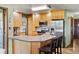 Well-appointed kitchen featuring stainless steel appliances, light wood cabinets, and granite countertops at 8571 W 71St Cir, Arvada, CO 80004