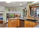 Spacious kitchen with wood cabinets, granite countertops, and an open design leading to other living areas at 8571 W 71St Cir, Arvada, CO 80004