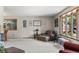 Spacious living room with neutral colors, large windows, and two cozy armchairs at 8571 W 71St Cir, Arvada, CO 80004