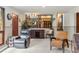 Spacious living room with wood trim and views through to the dining room and kitchen at 8571 W 71St Cir, Arvada, CO 80004