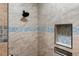 Shower stall showcasing neutral tile, a shower niche and modern fixtures at 8571 W 71St Cir, Arvada, CO 80004