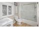 Well-lit bathroom featuring a glass-enclosed shower, modern sink, toilet, and unique leaded glass windows at 836 E 17Th Ave # 2B, Denver, CO 80218