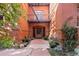 Entrance to brick building with courtyard, walkway, benches, and mature landscaping at 836 E 17Th Ave # 2B, Denver, CO 80218