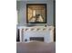 The fireplace is the focal point, showcasing a detailed mantel and a captivating piece of art at 836 E 17Th Ave # 2B, Denver, CO 80218