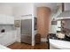 Stainless steel refrigerator in a modern kitchen with white cabinets and tiled backsplash at 836 E 17Th Ave # 2B, Denver, CO 80218