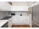 Bright kitchen featuring white cabinets, quartz countertops and stainless steel appliances at 836 E 17Th Ave # 2B, Denver, CO 80218