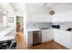 Modern kitchen with white cabinetry, quartz countertops, and stainless steel appliances at 836 E 17Th Ave # 2B, Denver, CO 80218