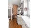The modern kitchen features white cabinets, stainless steel range hood and curved wall at 836 E 17Th Ave # 2B, Denver, CO 80218