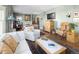 Open living room with hardwood floors, classic fireplace, and comfortable seating arrangements at 836 E 17Th Ave # 2B, Denver, CO 80218