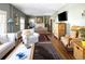 Spacious living room boasts hardwood floors, fireplace, and a comfortable seating area with a TV at 836 E 17Th Ave # 2B, Denver, CO 80218