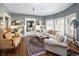Cozy living room featuring natural light, built-in shelving, a ceiling fan, and hardwood floors at 836 E 17Th Ave # 2B, Denver, CO 80218