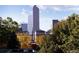 City skyline view featuring modern skyscrapers surrounded by lush trees, showcasing urban living at its finest at 836 E 17Th Ave # 2B, Denver, CO 80218