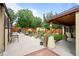 Backyard with a covered patio, landscaping, shed, and plenty of space for outdoor activities at 1470 S Yates St, Denver, CO 80219