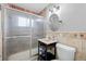 Bathroom features tiled shower, updated vanity and fixtures at 1470 S Yates St, Denver, CO 80219