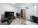 Bedroom area with wood floor and a sliding barn door closet for functional storage at 1470 S Yates St, Denver, CO 80219