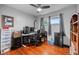 Bedroom with updated windows, ceiling fan and wood floors at 1470 S Yates St, Denver, CO 80219