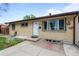 Lovely home featuring a brick facade, well-manicured landscaping, and a welcoming entrance at 1470 S Yates St, Denver, CO 80219