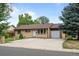 Charming single-story home features a well-maintained lawn and a large driveway at 1470 S Yates St, Denver, CO 80219