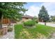 Charming brick home with a well-maintained front lawn and mature trees at 1470 S Yates St, Denver, CO 80219