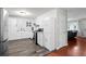 Modern kitchen featuring white cabinets, stainless steel appliances, and ample counter space at 1470 S Yates St, Denver, CO 80219
