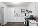 Bright kitchen features white cabinets, modern appliances, stainless sink and modern fixtures at 1470 S Yates St, Denver, CO 80219