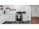 Updated kitchen with modern appliances, stone countertops and floating shelving at 1470 S Yates St, Denver, CO 80219