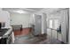 An updated kitchen, that looks into a second living space and additional stairwell to another floor at 1470 S Yates St, Denver, CO 80219