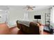Comfortable living room with hardwood floors, ceiling fan, and sliding glass doors at 1470 S Yates St, Denver, CO 80219