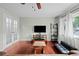 Comfortable living room with hardwood floors, ceiling fan, and French doors at 1470 S Yates St, Denver, CO 80219