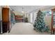 Living room with piano and Christmas decorations, chandelier, and multiple windows at 1470 S Yates St, Denver, CO 80219