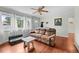 Bright living room featuring hardwood floors, a ceiling fan, and natural light at 1470 S Yates St, Denver, CO 80219