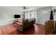 Inviting living room featuring beautiful hardwood floors, a ceiling fan, and a large window at 1470 S Yates St, Denver, CO 80219