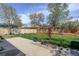 Spacious backyard featuring a grassy area, a garden bed, and concrete patio at 41 Cortez St, Denver, CO 80221