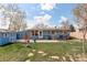 Charming backyard featuring a shed, patio, and a lush green lawn on a sunny day at 41 Cortez St, Denver, CO 80221