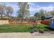 Spacious backyard featuring a grassy area, a garden bed, and concrete patio at 41 Cortez St, Denver, CO 80221