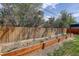 Backyard featuring a wooden fence, a garden bed, and greenery, making it perfect for outdoor activities at 41 Cortez St, Denver, CO 80221