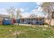 Spacious backyard showcasing a storage shed, a patio, and ample green space at 41 Cortez St, Denver, CO 80221