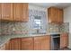 Well-lit kitchen showcases wood cabinets, granite countertops, tile backsplash, and stainless steel dishwasher at 41 Cortez St, Denver, CO 80221